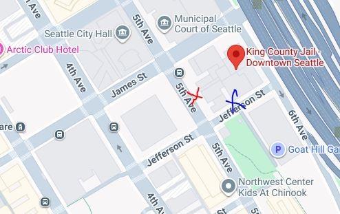 Image of Google Maps location of the King County Jail. A red X on 5th Avenue indicates the main exit and a blue X on Jefferson St indicates the secondary exit.